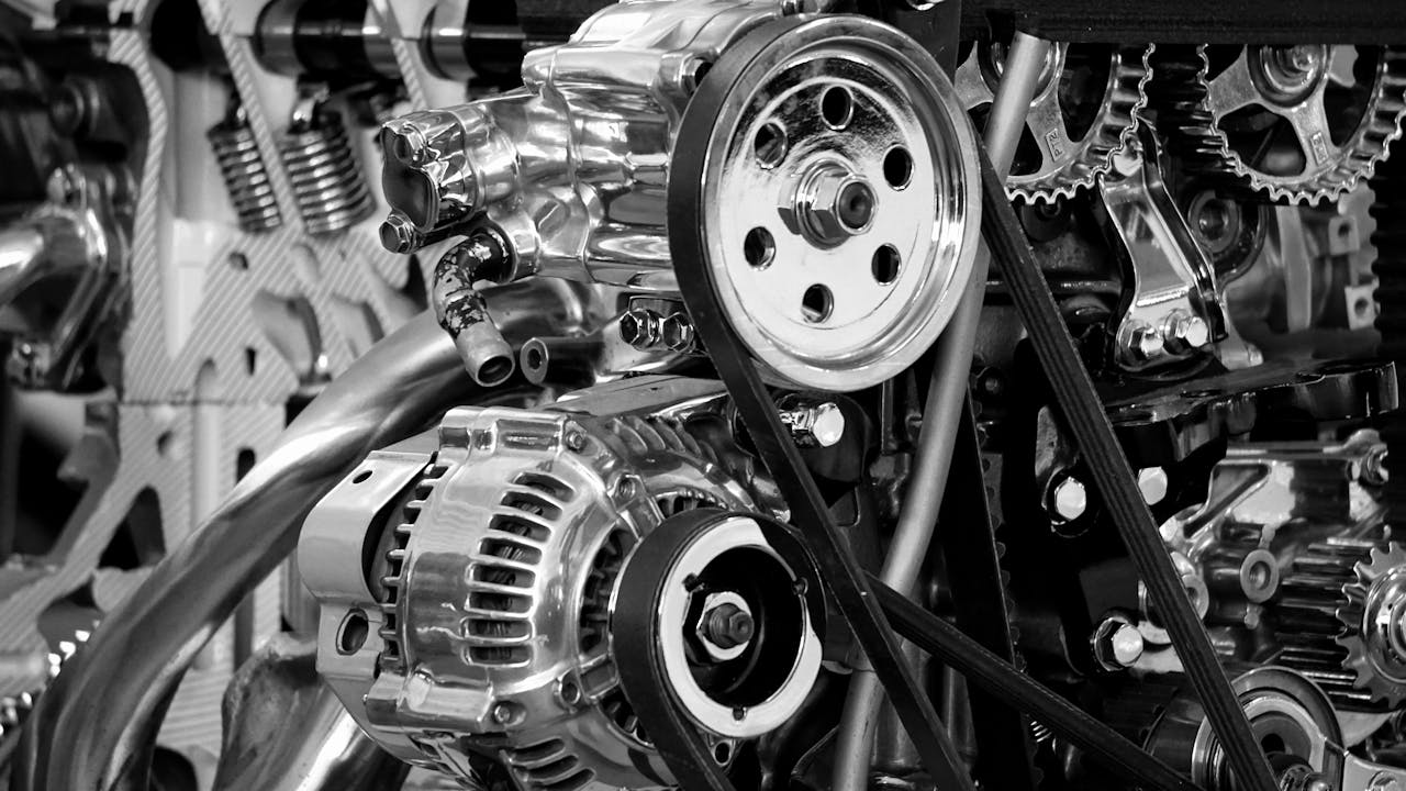 Home Close-up of a shiny car engine showing polished metal parts and gears in black and white.